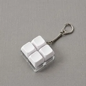 Detail view of a 4-key mechanical keyboard fidget toy keychain featuring white blank keycaps.