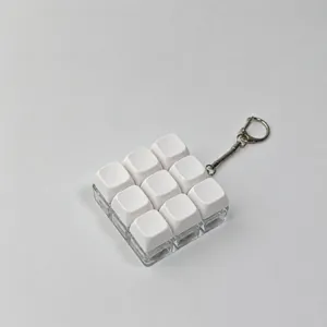Detailed macro view of a 9-key white mechanical keyboard switch fidget keychain