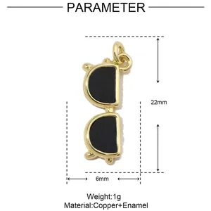 Macro view of gold-plated sunglasses charm pendant with black enamel detail