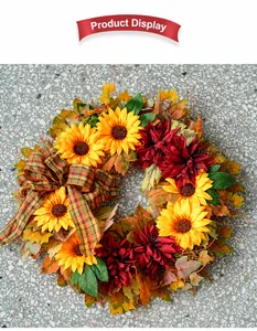Detailed view of autumn sunflower wreath with large plaid bow on stone background