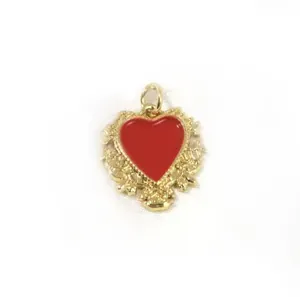 Close-up detail of ornate gold-plated red heart pendant for DIY jewelry accessories
