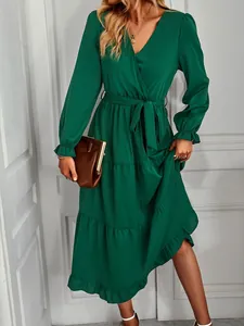 Elegant emerald green long sleeve V-neck tiered maxi dress displayed on a model