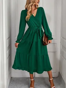 Elegant dark green long sleeve tiered midi dress with V-neckline and tie-waist detail