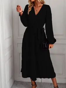 Elegant black long-sleeved tiered wrap dress for women, perfect for spring/summer casual wear.