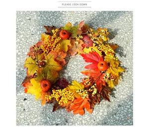 Close-up detail of autumn harvest wreath featuring maple leaves berries and mini pumpkins