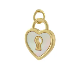 Detailed macro view of a gold-plated heart-shaped lock pendant with white pearl inlay