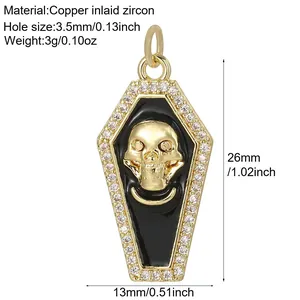 Detailed view of gold coffin skull pendant with zircon inlay and black enamel details.