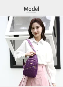 Detailed view of stylish purple embroidered nylon chest bag worn by model for daily travel