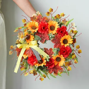 Autumn sunflower wreath with red roses and striped bow for harvest festival door decor