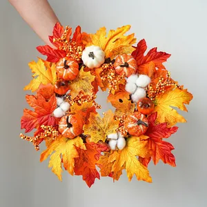 Autumn maple leaf wreath with mini pumpkins and cotton bolls for harvest festival
