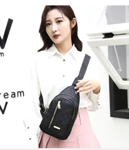 Close-up of a stylish black quilted nylon chest bag worn by a model for daily travel