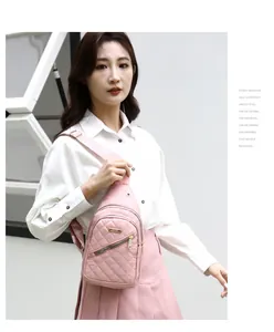 Detailed shot of a stylish pink quilted nylon chest bag worn by a model in a casual setting