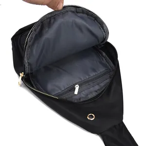 Stylish black nylon chest bag for women showing spacious grey interior with inner zipper pocket