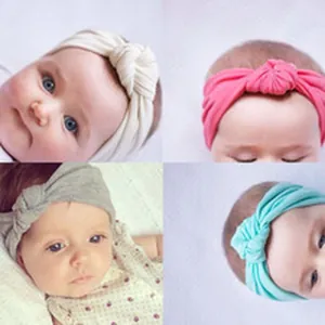 Detail view of four colorful soft cotton knotted headbands for infants