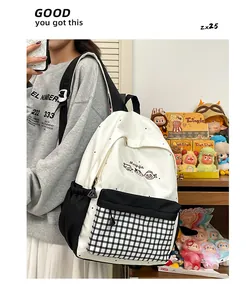 Close-up of cute embroidered backpack with black and white grid pattern