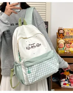 Cute embroidered backpack with pastel green grid details worn by a stylish student