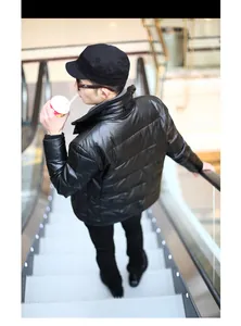 Male model wearing a stylish black flat top military cap in a shopping mall