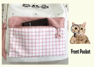 Detailed view of the front zipper pocket on a cute pink and white plaid school backpack