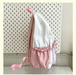 Side view of cute pink and white color-block backpack with grid pattern pocket