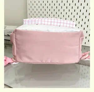 Detailed bottom view of a cute pink and white gingham backpack for school students