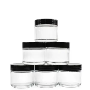Close-up detail of 2oz transparent glass cosmetic jars with black screw lids