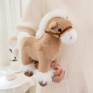 Close-up of a soft brown and white plush pony toy held in hand showing fluffy fur texture
