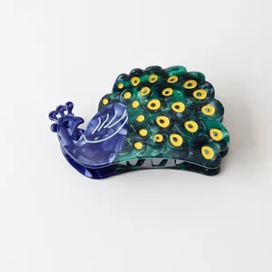 Acetate peacock hair claw clip featuring intricate feather patterns and vibrant colors