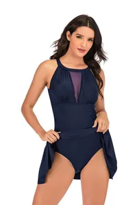 Detail of navy blue one-piece swimdress with mesh V-neck and ruffled skirt hem