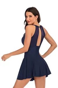 Back view of navy blue one-piece swim dress with elegant mesh inserts and modest skirt