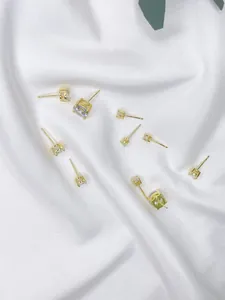 Detailed macro view of minimalist s925 sterling silver four-prong cubic zirconia stud earrings.