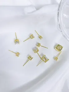 Close-up of elegant gold-plated S925 silver stud earrings with square cubic zirconia