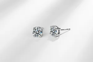 Detailed close-up of s925 sterling silver four-prong stud earrings with cubic zirconia