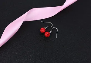 Close-up of red crystal ball drop earrings with S925 silver hooks on black background