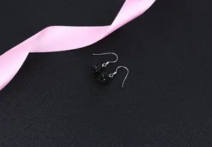 Close-up detail of black crystal ball Shamballa drop earrings in S925 sterling silver