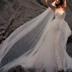 Close-up of a long white single-layer wedding veil with a sweeping cathedral train.