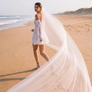Elegant long white sheer bridal veil with trailing cathedral length for wedding photography