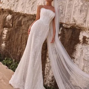Detailed view of an elegant long white wedding veil with a flowing trailing design.