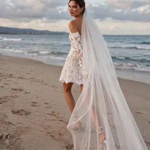 Elegant long white single-layer bridal veil with trailing edge on a scenic beach background