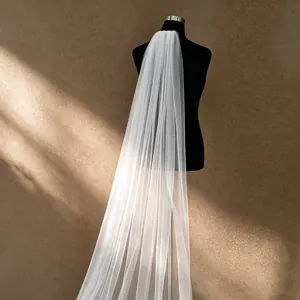 Professional view of an elegant pure white long single-layer cathedral wedding veil.