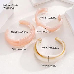 Detail view of acrylic irregular open bangles with dimensions and marble texture