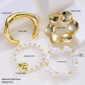 Close-up detail of acrylic gold open bangle and pearl bracelet set with measurements