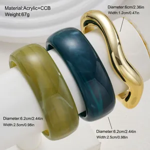 Detailed view of acrylic and gold-toned irregular bangle set with size measurements.