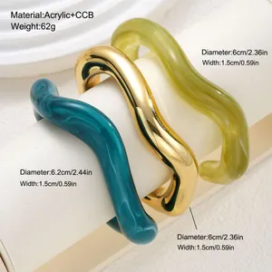 Detailed view of three irregular wavy acrylic bangles in gold, teal, and lime green.