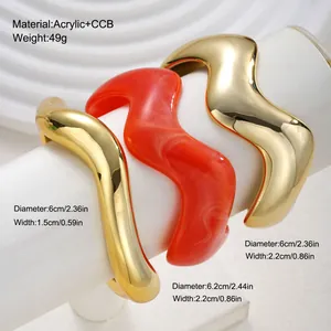 Macro view of irregular wavy acrylic and gold-toned bracelets with size specs