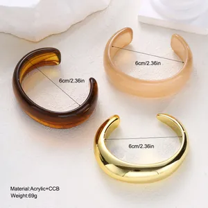 Close-up showing the material texture and 6cm diameter of the acrylic cuff bracelets