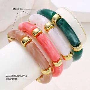 Detail view of colorful acrylic tube bracelets with gold accents and 24cm circumference.