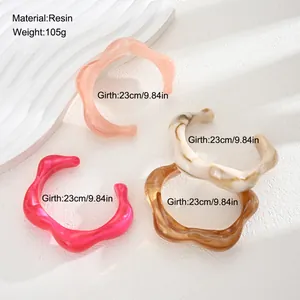 Detailed macro view of irregular resin bangles with girth and material info.