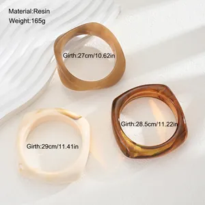 Detail view of resin irregular bangle set with size and material specifications