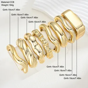 Close-up of 8 chunky gold CCB bangle bracelets with dimensions and material info