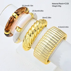 Close-up of a four-piece resin and gold-tone chunky bracelet set with measurements.
